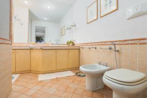 a bathroom with a toilet and a sink at Bella Vista Marinella 1 in Olbia +19 photos