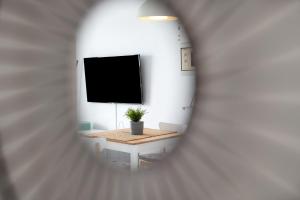 a view of a room with a table and a tv at Casa Paloma in Costa Teguise