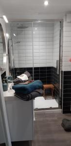 a bathroom with a sink and a shower with towels at La Musicale in Rouen +25 photos