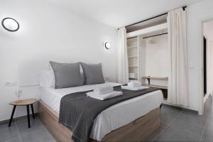 a white bedroom with a large bed with towels on it at Casa Paloma in Costa Teguise +15 photos