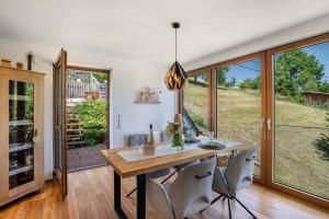 a dining room with a table and chairs and sliding glass doors at Ferienwohnung s'Raubers in Bühlertal