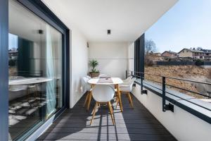 a balcony with a table and chairs and large windows at bei Stefanie in Bad Koetzting