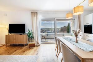 a kitchen and dining room with a table and a television at bei Stefanie in Bad Koetzting