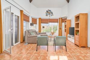 a living room with a couch and a table and chairs at Villa Amapola in Caserío Carraspite