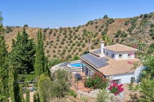 an aerial view of a house with a mountain at Villa Amapola in Caserío Carraspite