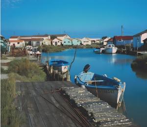 two boats are docked at a dock in the water at Maison Sulz in Montendre +5 photos