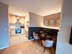 a kitchen and living room with a table and chairs at Apartment Kokorey in Halstenbek