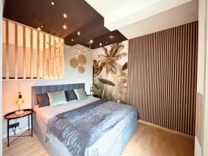 a bedroom with a large bed and a wooden wall at Apartment Kokorey in Halstenbek