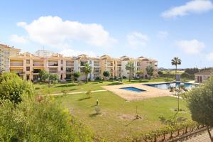 a view of a resort with a swimming pool at Columbus Beach Apartment in Quarteira