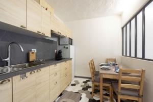 a kitchen with a table and a dining room at Charmant studio 2 in Courchevel +5 photos