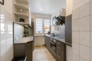 a kitchen with a sink and a stove top oven at Ferienwohnung San Marino 3 in Mücheln