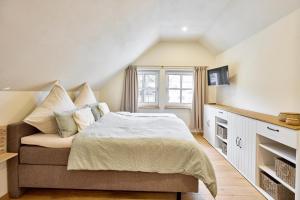 a bedroom with a large bed and a window at Haus Auergang Schmallenberg in Schmallenberg