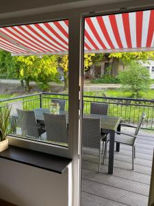 a patio with a table and chairs on a deck at Haus Auergang Schmallenberg in Schmallenberg