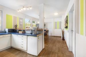 a kitchen with white cabinets and a blue counter top at Edos Private Zimmervermietung in Birstein