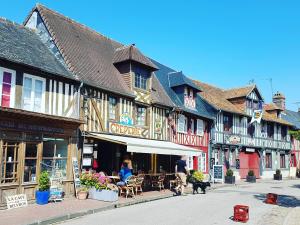 a group of buildings on a street in a town at Jo And Manu's Barn in Falaise