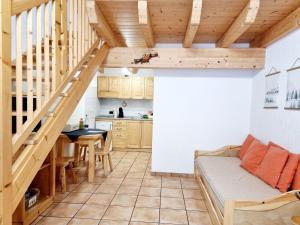 a kitchen and dining room with a staircase in a tiny house at Appartamento Adamello 13 in Pinzolo