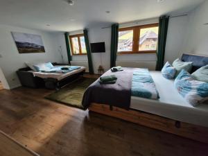 a bedroom with a large bed and a couch at Ferienwohnung Vordere Halde in Elzach