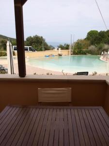 a view of a swimming pool from the balcony of a house at La Pergola al Cavo 5 in Cavo