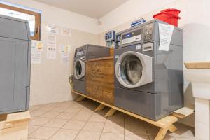 a laundry room with two washing machines on a shelf at Appartamento Adamello 13 in Pinzolo