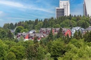 a group of houses on a hill with trees at Ferienwohnung Tannenblick 2-4 in Oberhof
