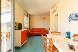a living room with a red couch and a table at La Pergola al Cavo 5 in Cavo