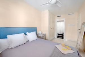 a bedroom with a bed with a book on it at Lopimar Exclusivo in Canet de Berenguer +22 photos