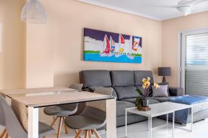 a living room with a table and a couch at Lopimar Exclusivo in Canet de Berenguer