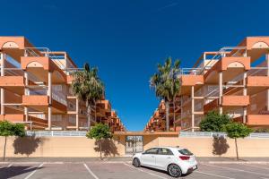 a car parked in a parking lot in front of a building at Lopimar Exclusivo in Canet de Berenguer