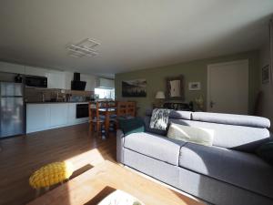 a living room with a couch and a kitchen at Appartement - Vue montagne in Cazeaux-de-Larboust +36 photos