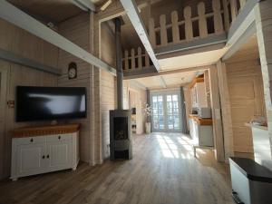 a large living room with a flat screen tv at Leonies Emsblick in Walchum +27 photos