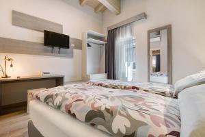 a bedroom with a bed and a flat screen tv at Casa Donati Lucia in Tremosine Sul Garda