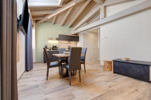 a kitchen and dining room with a table and chairs at Casa Donati Lucia in Tremosine Sul Garda +17 photos
