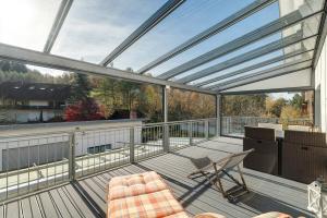 a balcony with a glass roof with a table and chairs at Forest Apartment - Renchen in Renchen