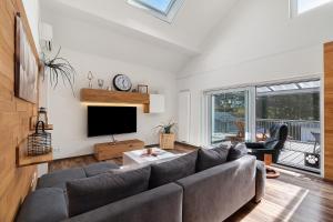 a living room with a couch and a tv at Forest Apartment - Renchen in Renchen