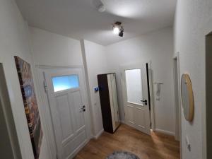 an empty hallway with two doors and a window at Max Hinterhaus in Dresden +5 photos