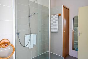 a bathroom with a shower with a glass door at Villa Rosella in Les Sables-d'Olonne +21 photos