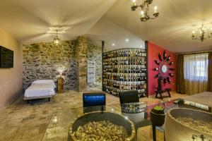 a large room with a bed and a room with a lot of books at Mas Renart in Mollet de Perelada +22 photos