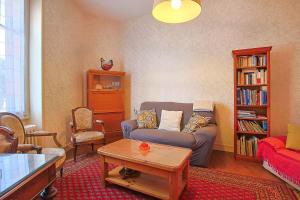 a living room with a couch and a coffee table at Villa Rosella in Les Sables-d'Olonne
