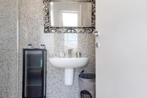 a bathroom with a sink and a mirror at Residenza La Fonte Dependance in Laveno-Mombello +22 photos