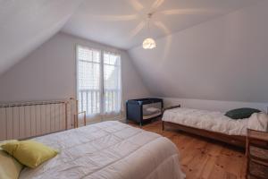 a bedroom with two beds and a window at Maison Anthian in Arcizans-Avant
