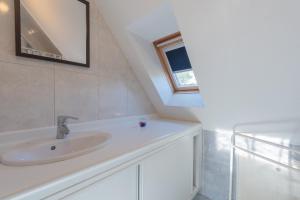 a bathroom with a sink and a window at Maison Anthian in Arcizans-Avant +20 photos