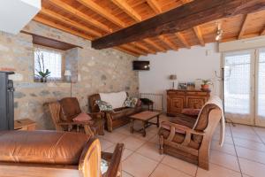 a living room with a couch and chairs at Maison Anthian in Arcizans-Avant