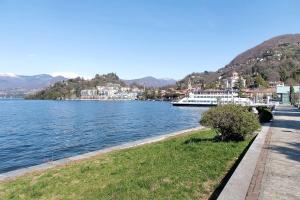 a boat is docked on the shore of a lake at Residenza La Fonte Dependance in Laveno-Mombello
