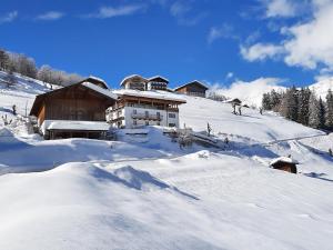 a house on a snow covered slope with snow at Joshof Bergblick in Moso
