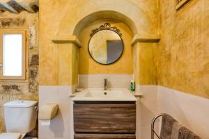 a bathroom with a sink and a toilet and a mirror at Villa - Oasis centre charme in Montpellier +18 photos