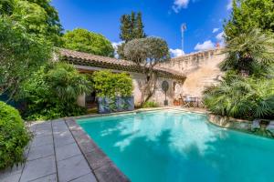 a swimming pool in the yard of a house at Villa - Oasis centre charme in Montpellier