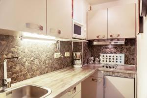 a kitchen with white cabinets and a wooden counter top at Ferienwohnungen St Christoph in Mittenwald