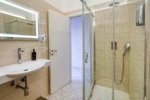 a bathroom with a sink and a shower at Sant'Oronzo House in Lecce +15 photos