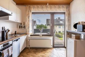 a kitchen with a large window and a sink at Ferienwohnung Sonnenschein in Bad Hersfeld