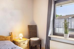 a bedroom with a bed and a window and a chair at Ferienwohnung Sonnenschein in Bad Hersfeld
